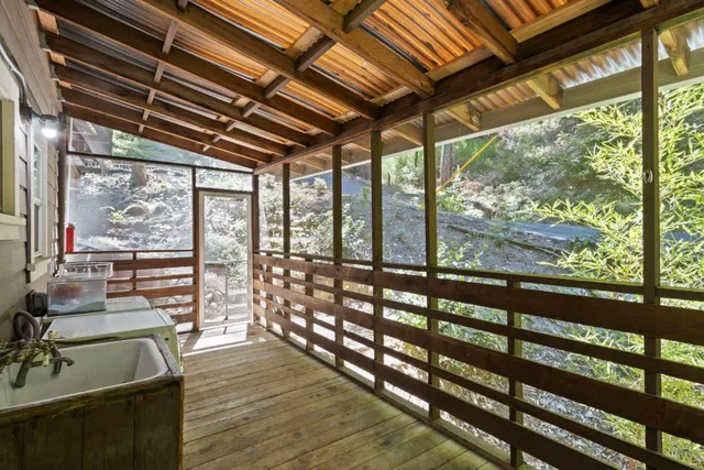 a backyard of a house with lots of plants and tree