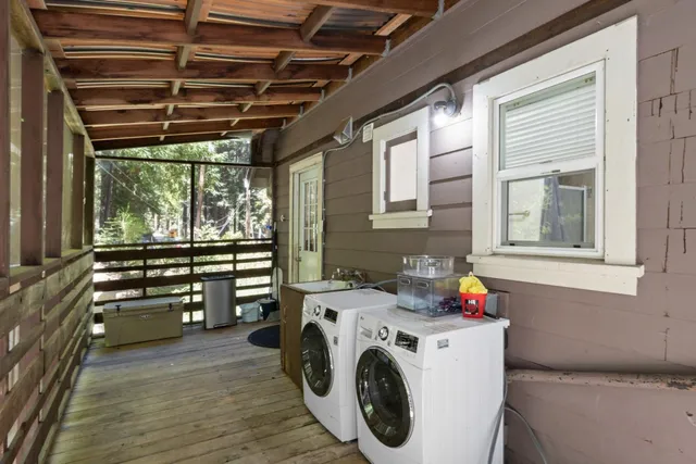 a view of a bench in the backyard with sitting area