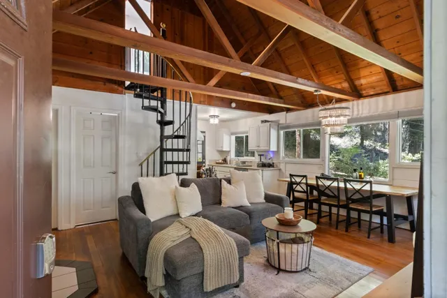 a living room with furniture wooden floor and a table
