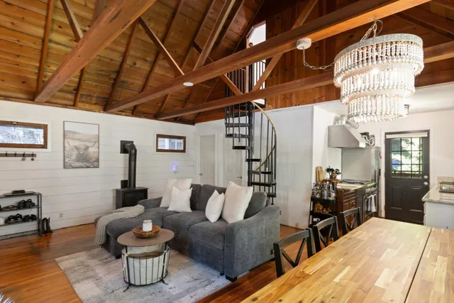 a kitchen with a stove and wooden floor