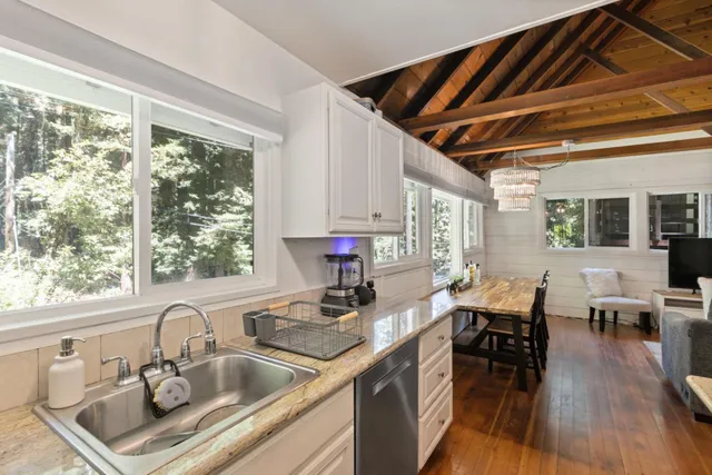 a view of a dining room with furniture large windows and wooden floor