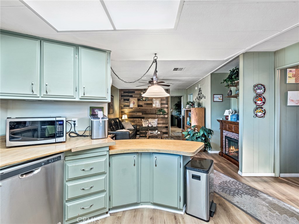 21922 Ottawa Road, Unit 8 Apple Valley, CA 92308 - Photo 13 of 31 a kitchen with stainless steel appliances granite countertop a stove a sink and a microwave