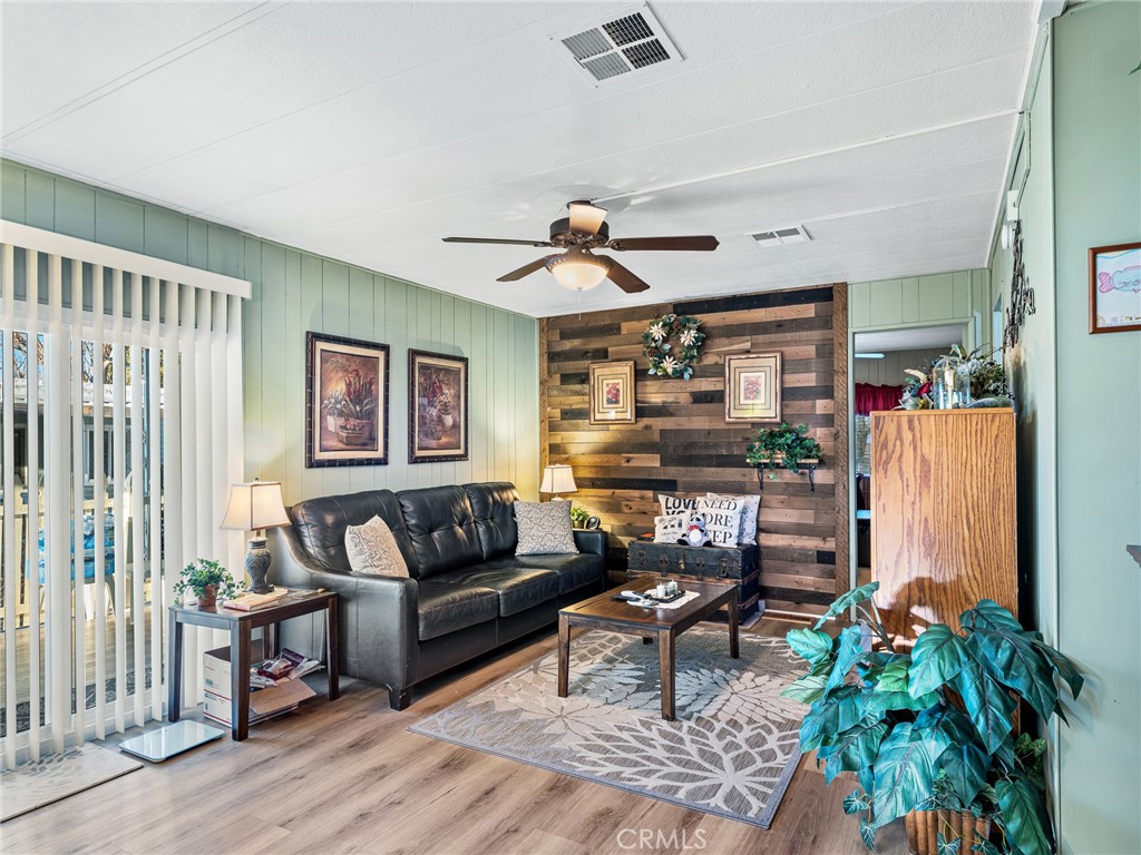 21922 Ottawa Road, Unit 8 Apple Valley, CA 92308 - Photo 14 of 31 a living room with furniture and a large window