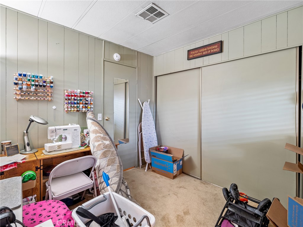 21922 Ottawa Road, Unit 8 Apple Valley, CA 92308 - Photo 19 of 31 a view of room with guitars and closet