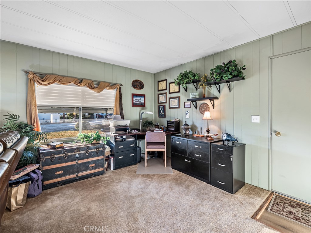 21922 Ottawa Road, Unit 8 Apple Valley, CA 92308 - Photo 2 of 31 a living room with furniture and a flat screen tv