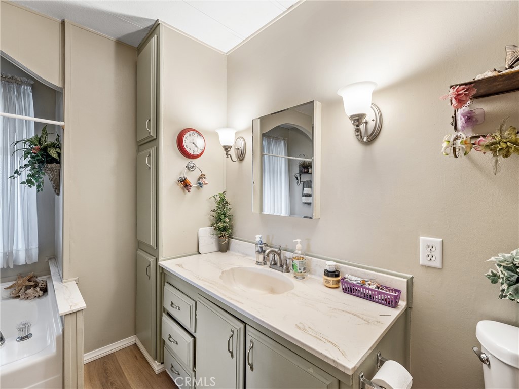 21922 Ottawa Road, Unit 8 Apple Valley, CA 92308 - Photo 22 of 31 a bathroom with a sink a vanity and a mirror