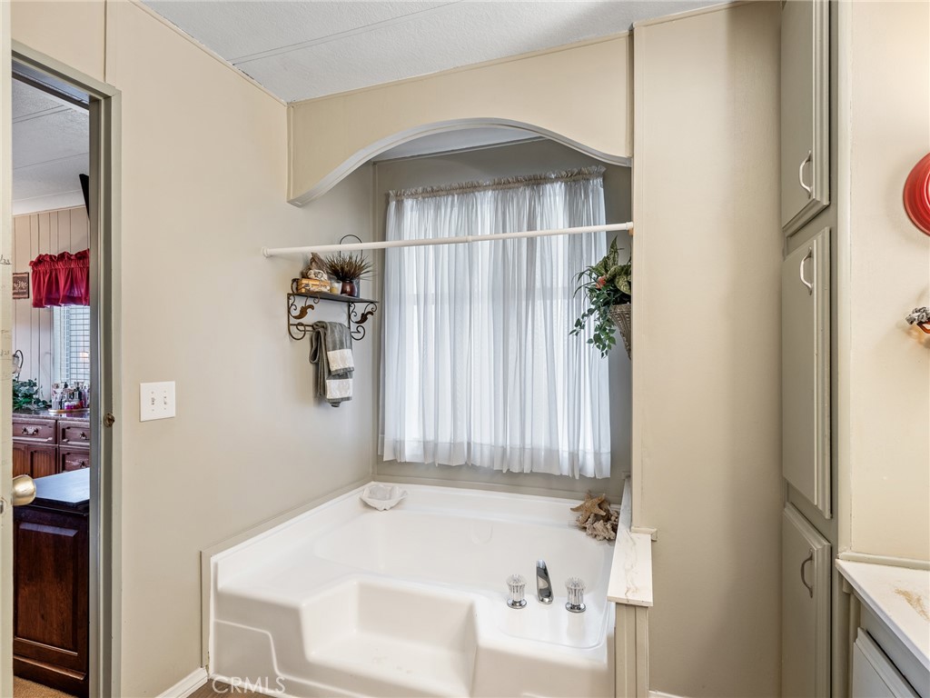 21922 Ottawa Road, Unit 8 Apple Valley, CA 92308 - Photo 23 of 31 a bathroom with a bathtub and shower