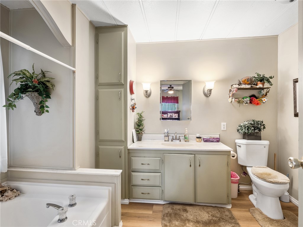21922 Ottawa Road, Unit 8 Apple Valley, CA 92308 - Photo 24 of 31 a bathroom with a sink a toilet and a mirror