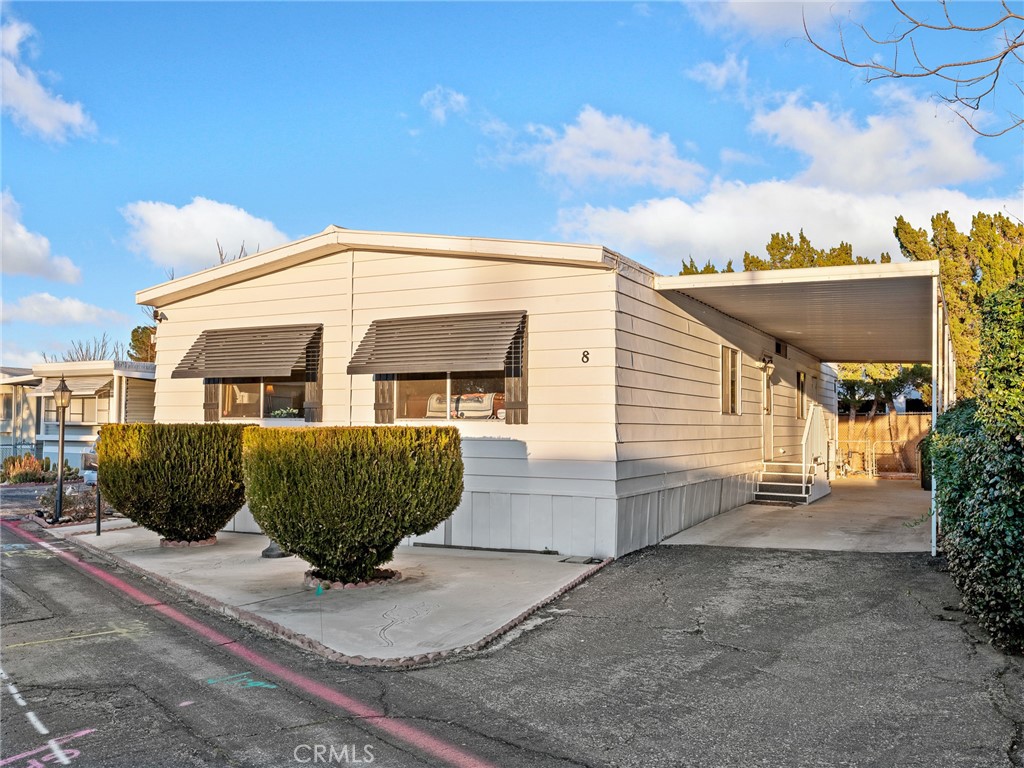 21922 Ottawa Road, Unit 8 Apple Valley, CA 92308 - Photo 30 of 31 a front view of a house with a garden