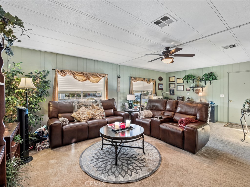 21922 Ottawa Road, Unit 8 Apple Valley, CA 92308 - Photo 6 of 31 a living room with furniture a dining table and a fireplace