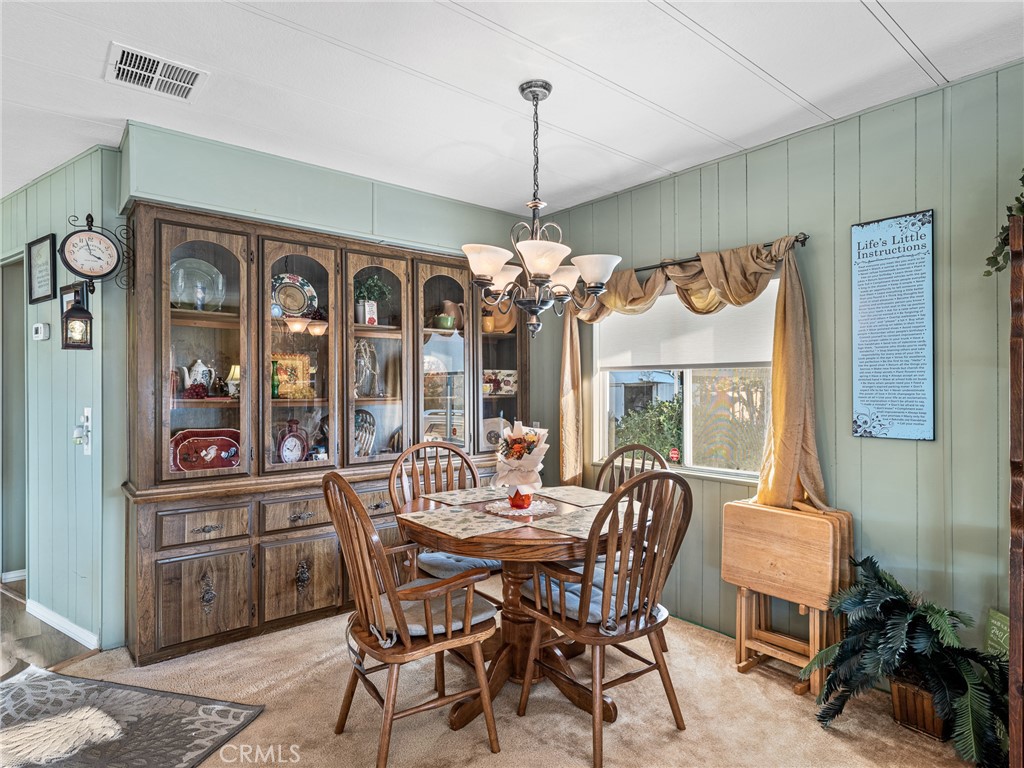 21922 Ottawa Road, Unit 8 Apple Valley, CA 92308 - Photo 9 of 31 a view of a dining room with furniture window and outside view