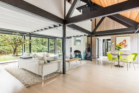 a living room with furniture a fireplace and a large window