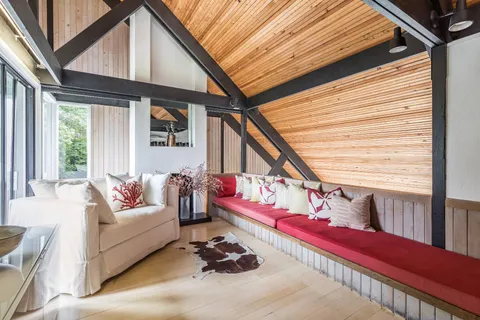 a balcony with furniture and wooden floor