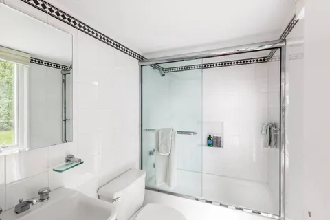 a bathroom with a sink toilet and shower