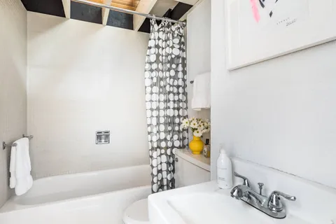 a bathroom with a bathtub and shower