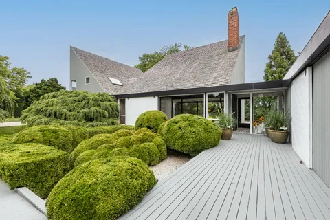 a view of a house with brick walls and potted plants