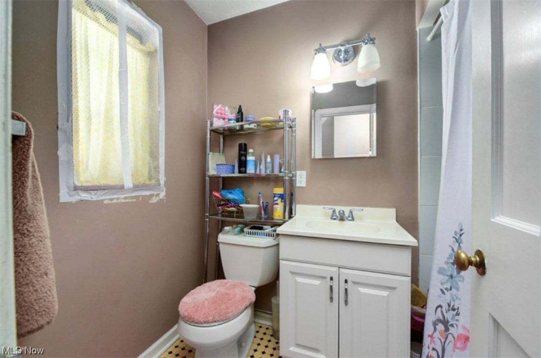 15902 Munn Road Cleveland, OH 44111 - Photo 19 of 27 Bathroom featuring vanity, tile flooring, and toilet