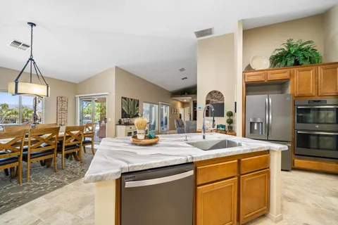 a kitchen with sink and refrigerator