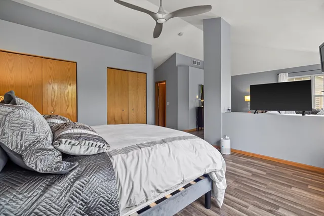 a bedroom with a bed and a flat screen tv