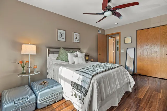 a bedroom with a bed and wooden floor