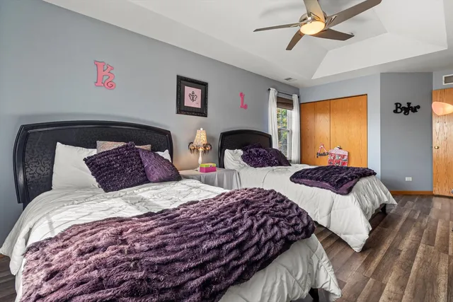 a bedroom with two beds and a chandelier
