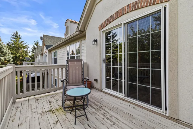 a view of a deck with wooden floor and outdoor seating