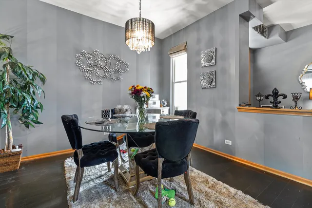 a dining room with furniture potted plants and wooden floor