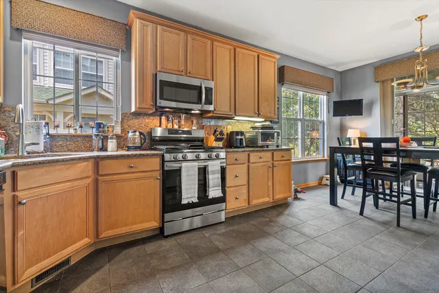a kitchen with appliances a sink and cabinets