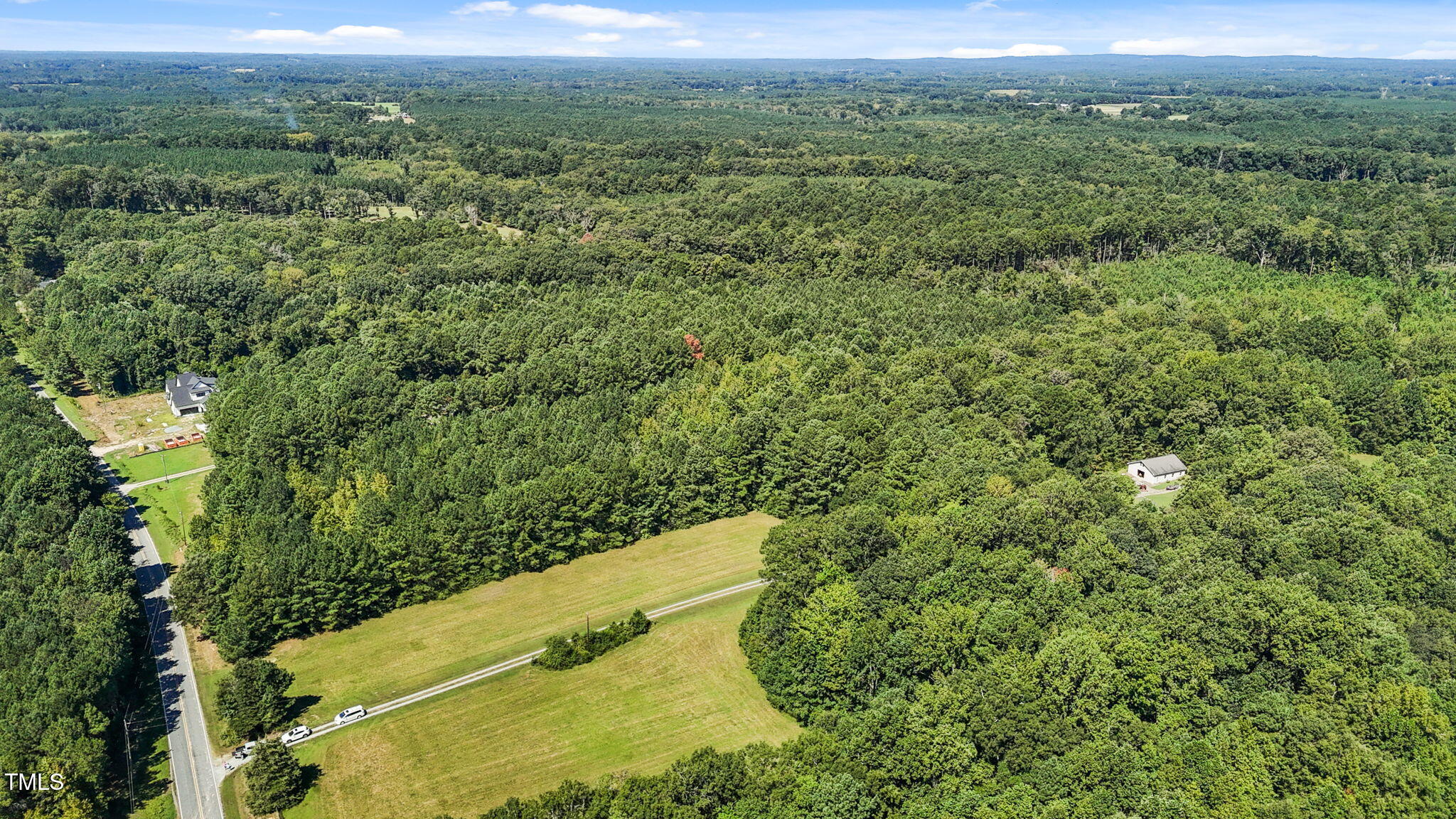 476 Pete Thomas Road Pittsboro, NC 27312 - Photo 7 of 16 a view of a city with lush green forest