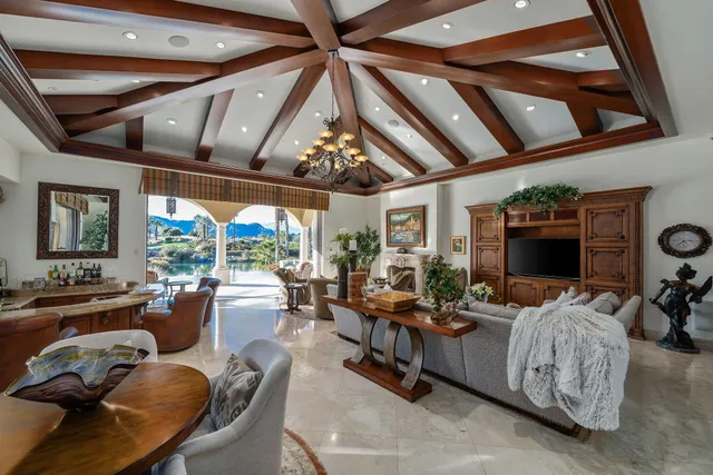 a living room with fireplace furniture and a chandelier