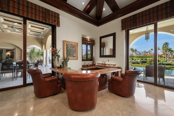 a living room with furniture a fireplace and a large window