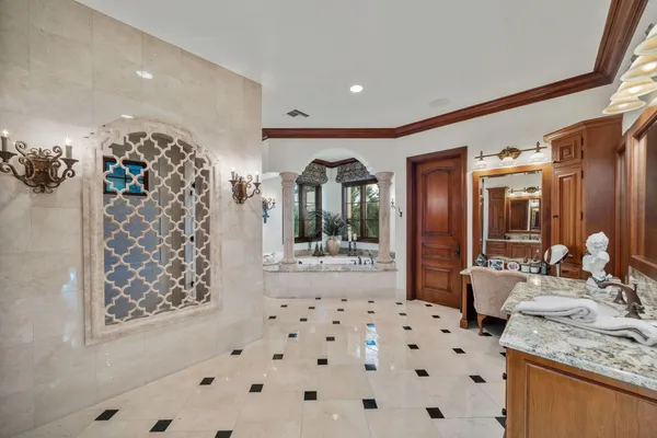 a living room with stainless steel appliances granite countertop furniture a fireplace a flat screen tv and kitchen view