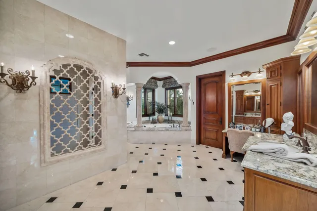 a living room with stainless steel appliances granite countertop furniture a fireplace a flat screen tv and kitchen view