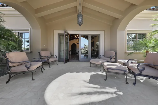 a view of a house with swimming pool and sitting area