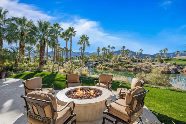 a view of a patio with table and chairs and potted plants