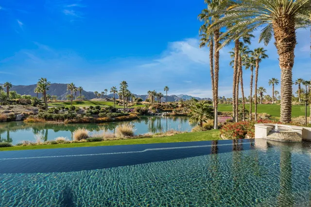 a living room with furniture a fireplace and a floor to ceiling window