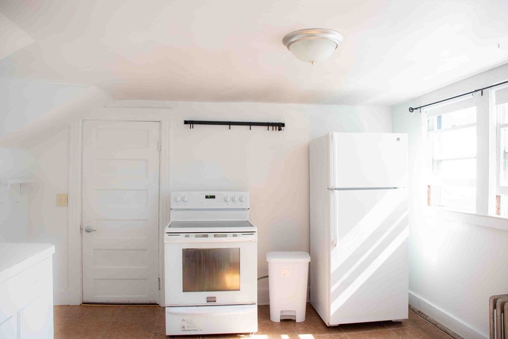 39 Sugarloaf Street, Unit 2 Deerfield, MA 01373 - Photo 1 of 7 a kitchen with a refrigerator and a stove