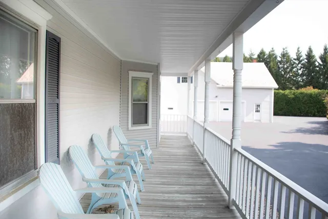 a view of deck with furniture and trees