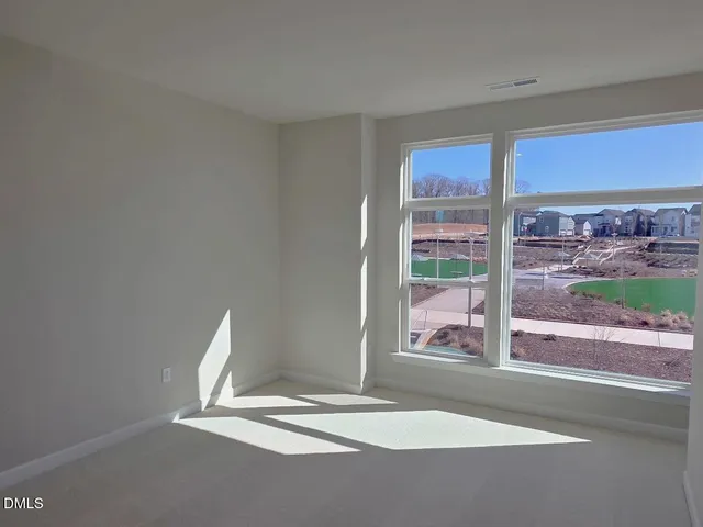 a view of a livingroom with wooden floor and a window