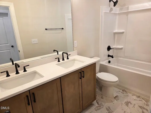 an aerial view of a house with a swimming pool and outdoor seating