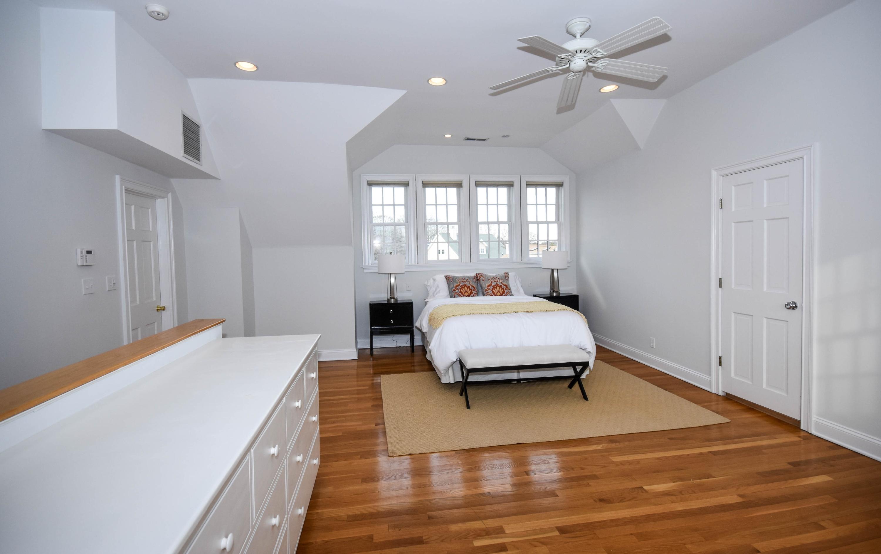 22 Meridian Road Rowayton, CT 06853 - Photo 17 of 25 a living room with a bed furniture chandelier and a window