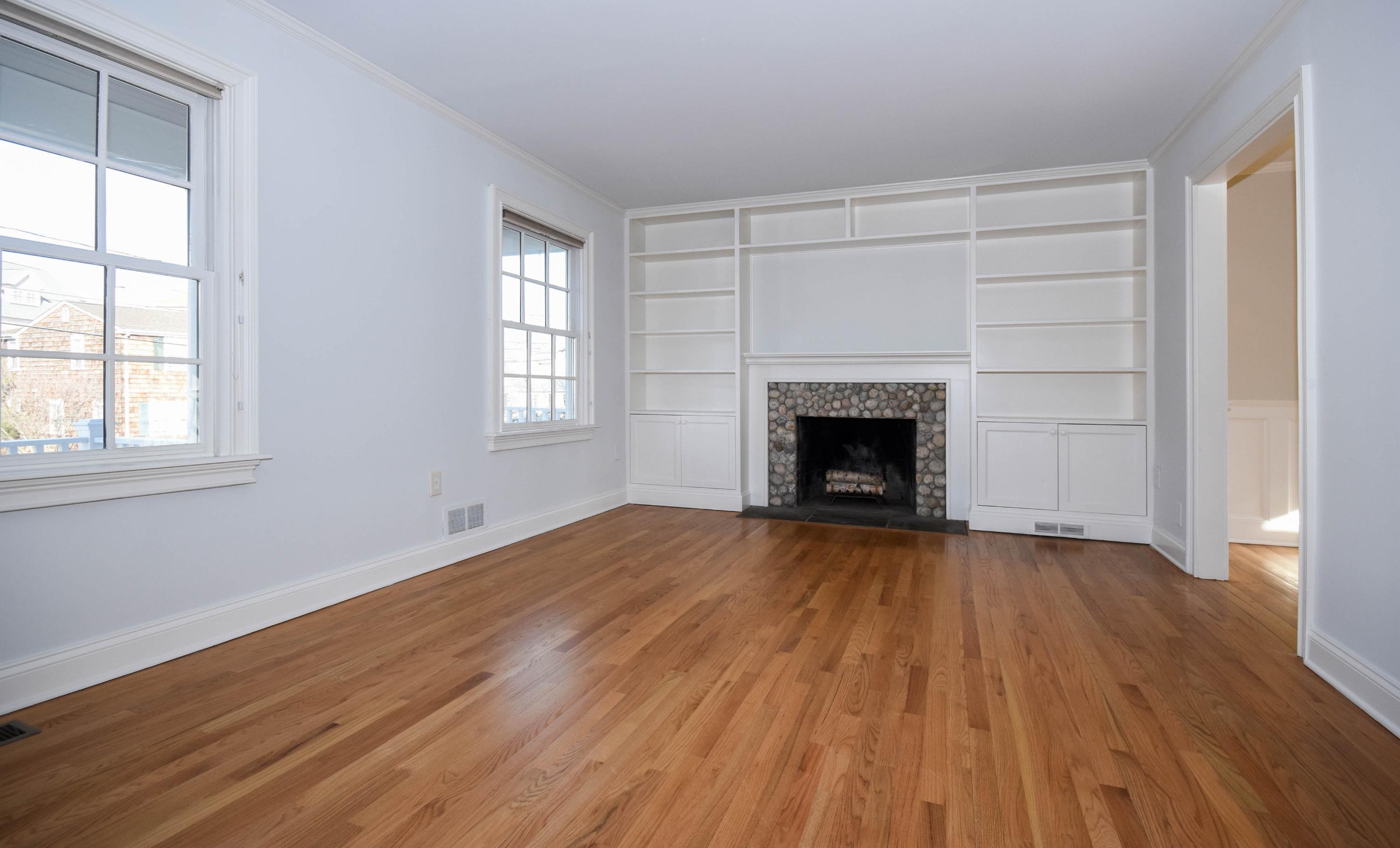 22 Meridian Road Rowayton, CT 06853 - Photo 8 of 25 an empty room with wooden floor fireplace and windows