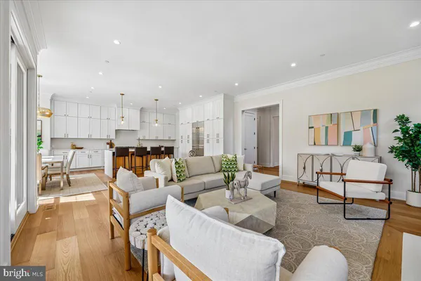 a kitchen with stainless steel appliances granite countertop a stove a kitchen island a table and chairs
