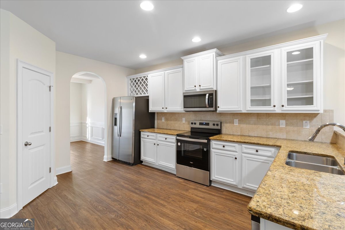 149 Mariahs Walk Hampton, GA 30228 - Photo 13 of 45 a kitchen with a sink a refrigerator a stove and cabinets