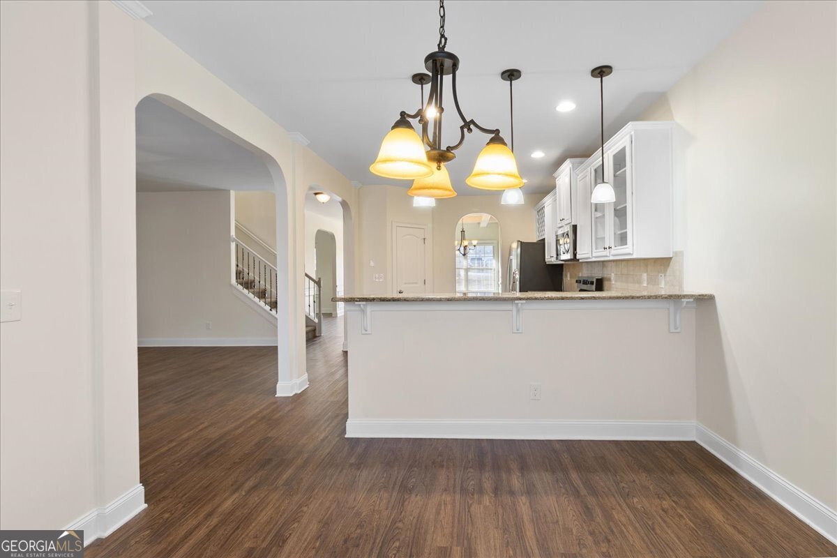 149 Mariahs Walk Hampton, GA 30228 - Photo 16 of 45 a view of a kitchen with wooden floor and a sink