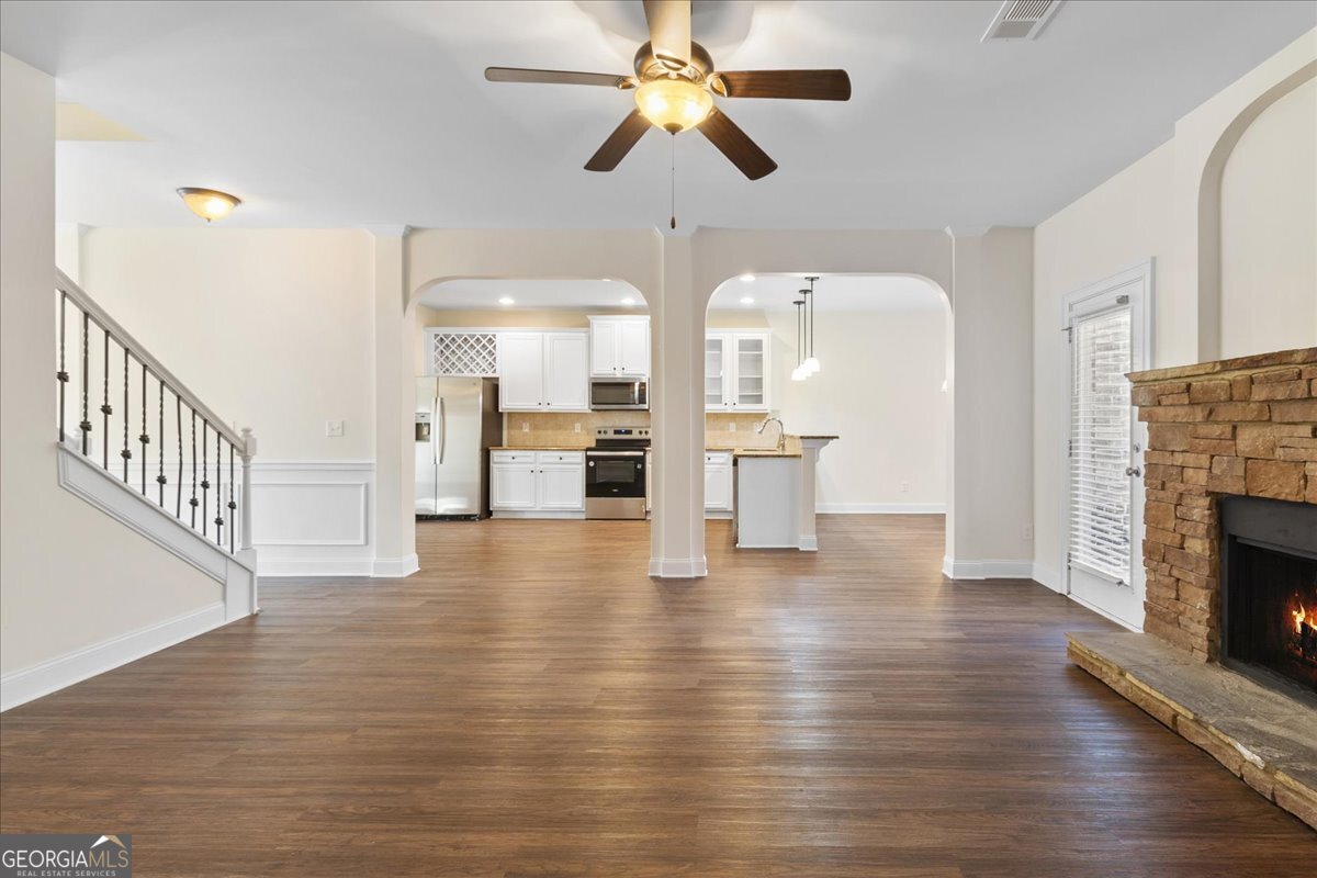 149 Mariahs Walk Hampton, GA 30228 - Photo 18 of 45 a view of an empty room with wooden floor fireplace and a window