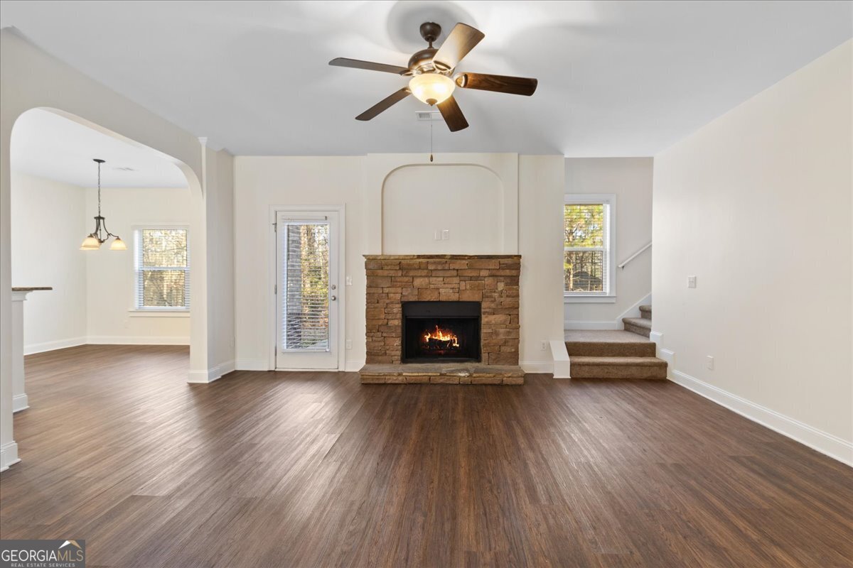 149 Mariahs Walk Hampton, GA 30228 - Photo 19 of 45 a view of a livingroom with a fireplace a ceiling fan and wooden floor