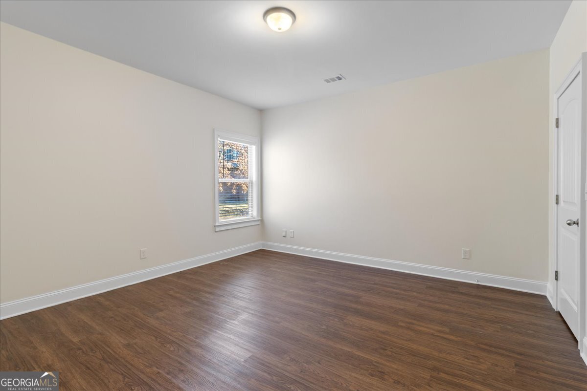 149 Mariahs Walk Hampton, GA 30228 - Photo 20 of 45 a view of an empty room with wooden floor and a window