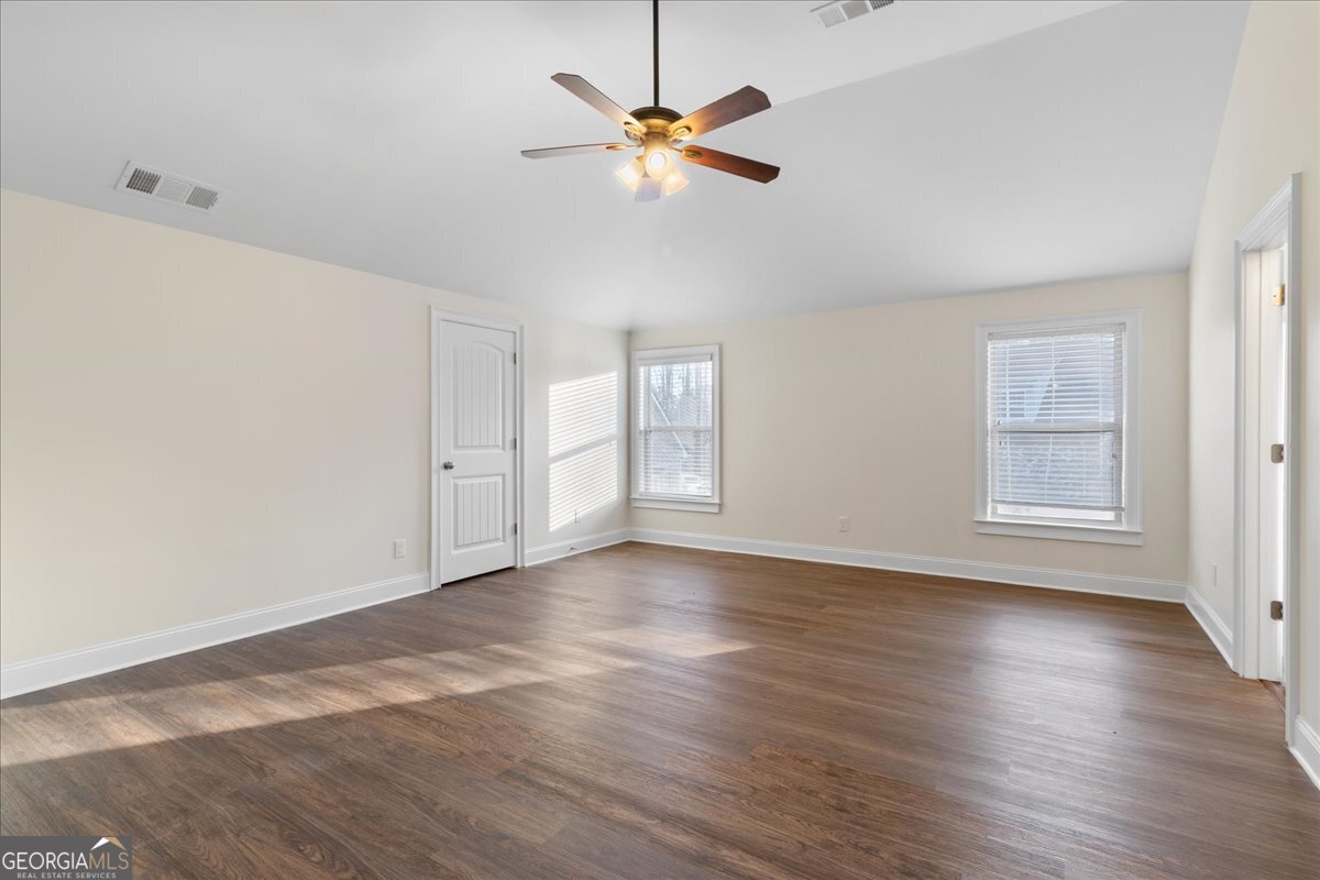 149 Mariahs Walk Hampton, GA 30228 - Photo 25 of 45 an empty room with wooden floor and window