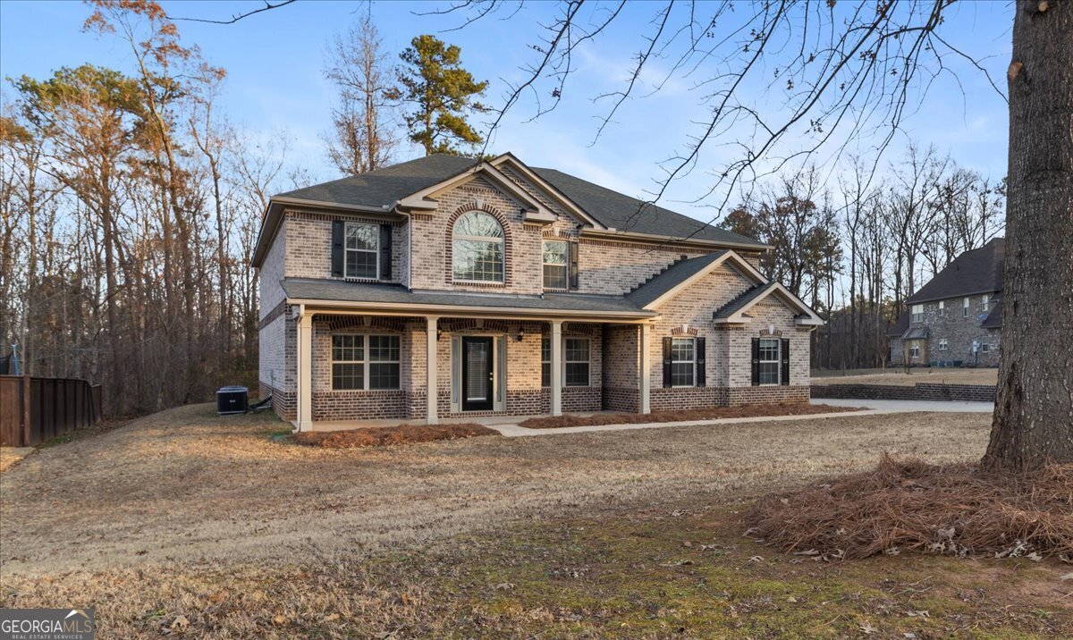 149 Mariahs Walk Hampton, GA 30228 - Photo 3 of 45 a front view of a house with a garden